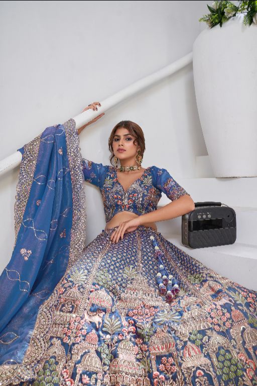 Teal Blue Raw Silk Bridal Lehenga Featuring Temple, Cow & Floral Embroidery