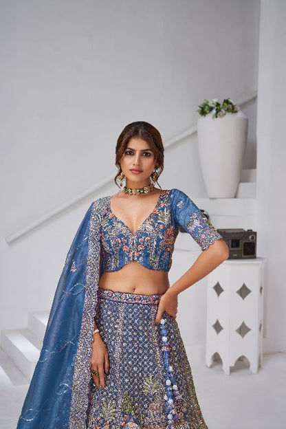 Teal Blue Raw Silk Bridal Lehenga Featuring Temple, Cow & Floral Embroidery